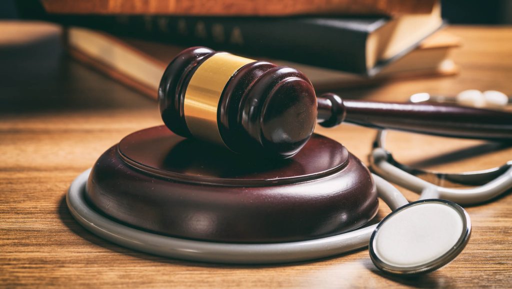 Stethoscope and judge's gavel on a desk | Featured image for the Healthcare Rights page for Restore Dental.