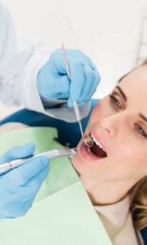 Dentist examining a female patient's teeth | Featured Image for the Chermside Dentist Home Page of Restore Dental.